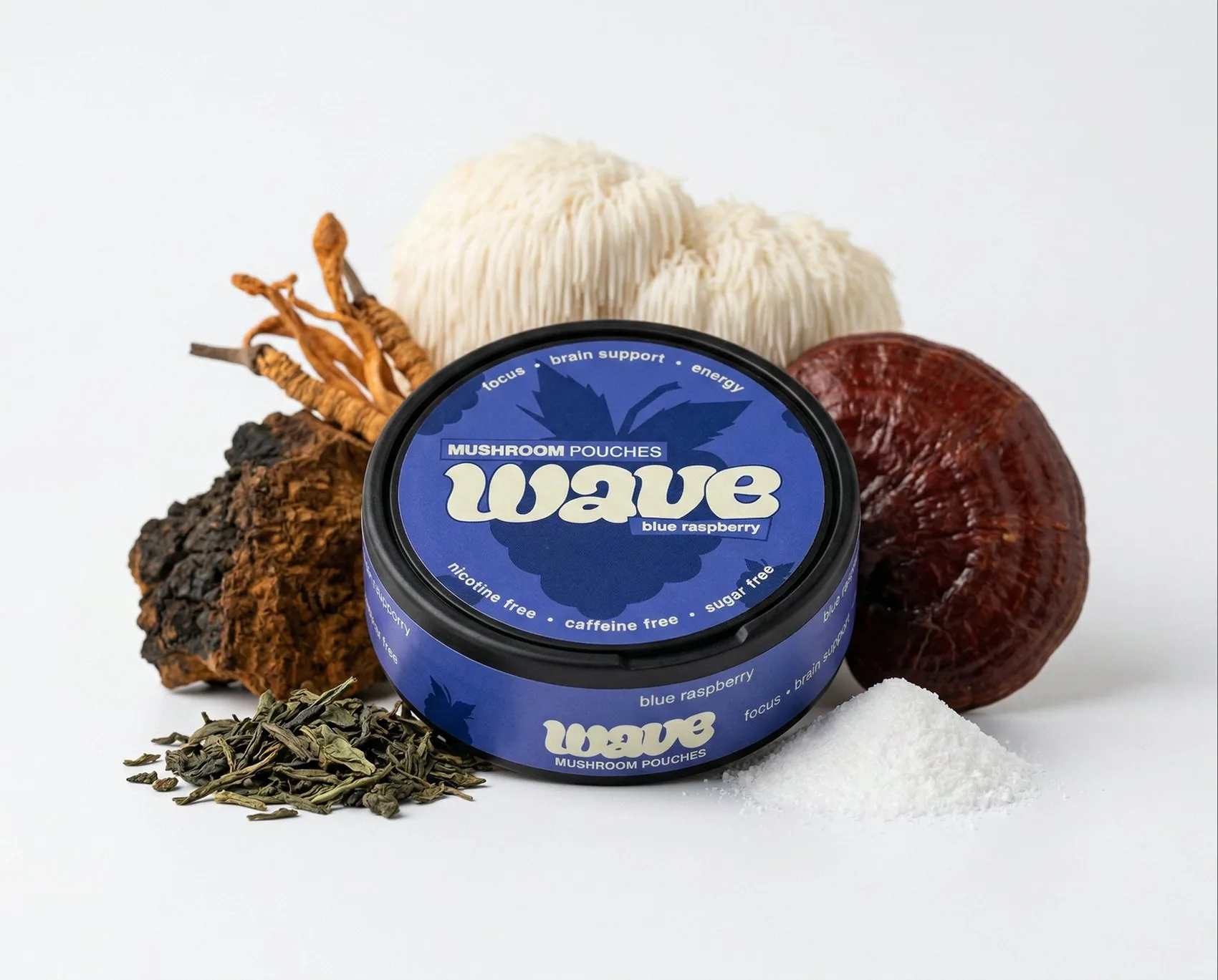 A WAVE can surrounded by whole mushrooms and loose tea leaves.